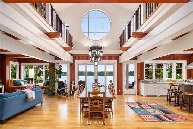 a living room with furniture a chandelier and a floor to ceiling window