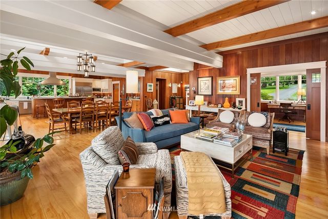 a living room with lots of furniture and a floor to ceiling window
