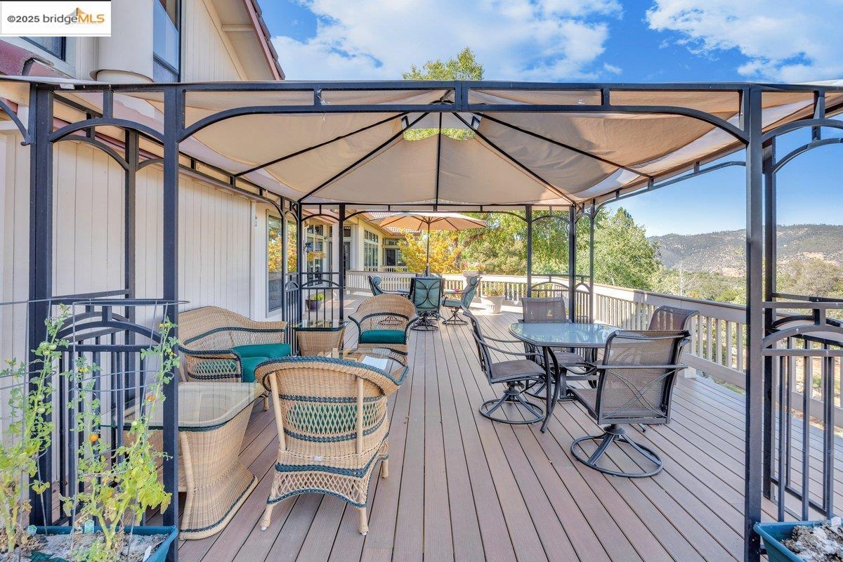 13700 Clements Road Groveland, CA 95321 - Photo 56 of 93 Wooden deck with outdoor dining area and a mountain view
