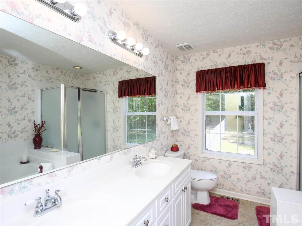 4040 Pine Ridge Road Franklinton, NC 27525 - Photo 12 of 30 a bathroom with a bathtub sink and mirror