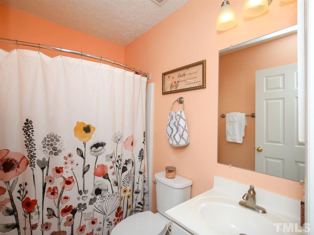 4040 Pine Ridge Road Franklinton, NC 27525 - Photo 14 of 30 a bathroom with a sink toilet and shower curtain