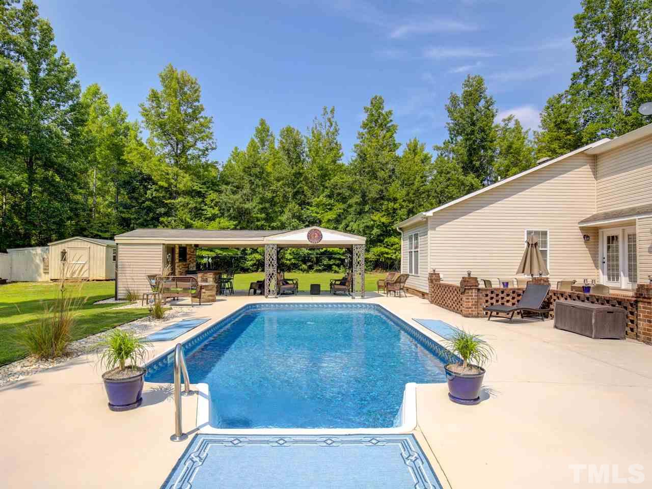 4040 Pine Ridge Road Franklinton, NC 27525 - Photo 24 of 30 a view of a patio with table and chairs potted plants with wooden fence