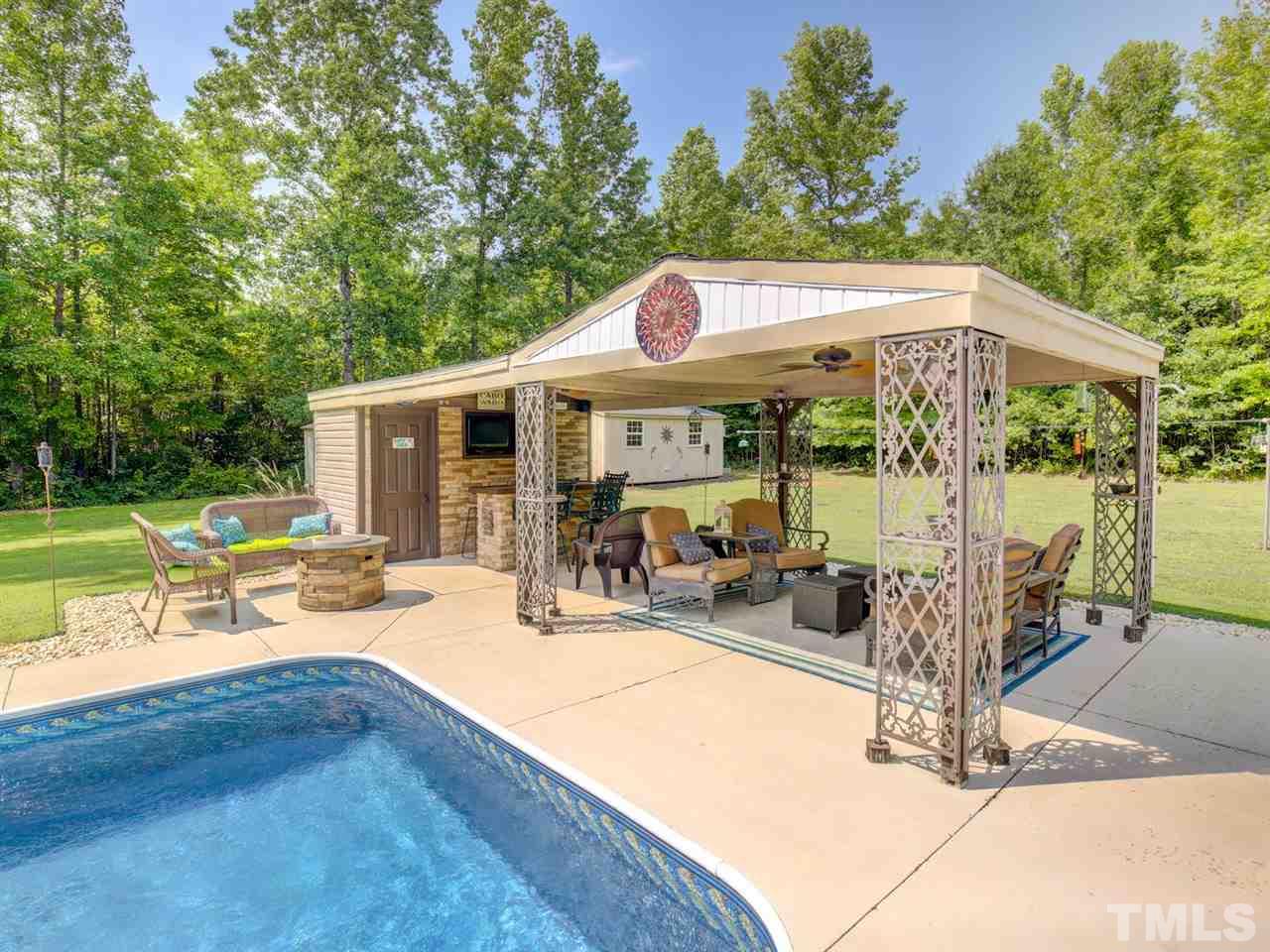 4040 Pine Ridge Road Franklinton, NC 27525 - Photo 25 of 30 a view of a patio with a table chairs and a floor to ceiling window