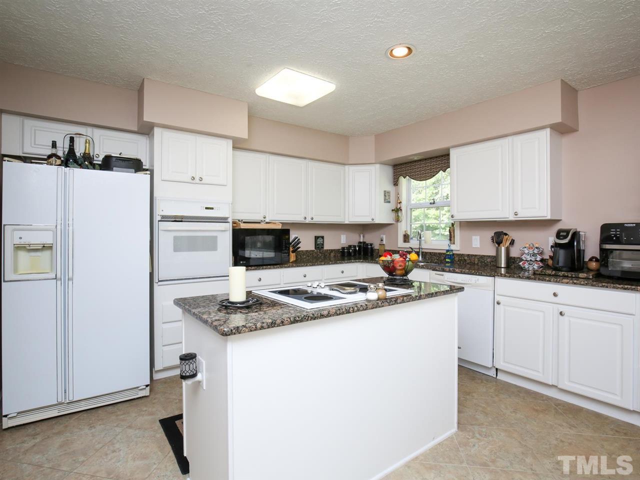 4040 Pine Ridge Road Franklinton, NC 27525 - Photo 8 of 30 a kitchen with stainless steel appliances granite countertop a refrigerator sink and white cabinets