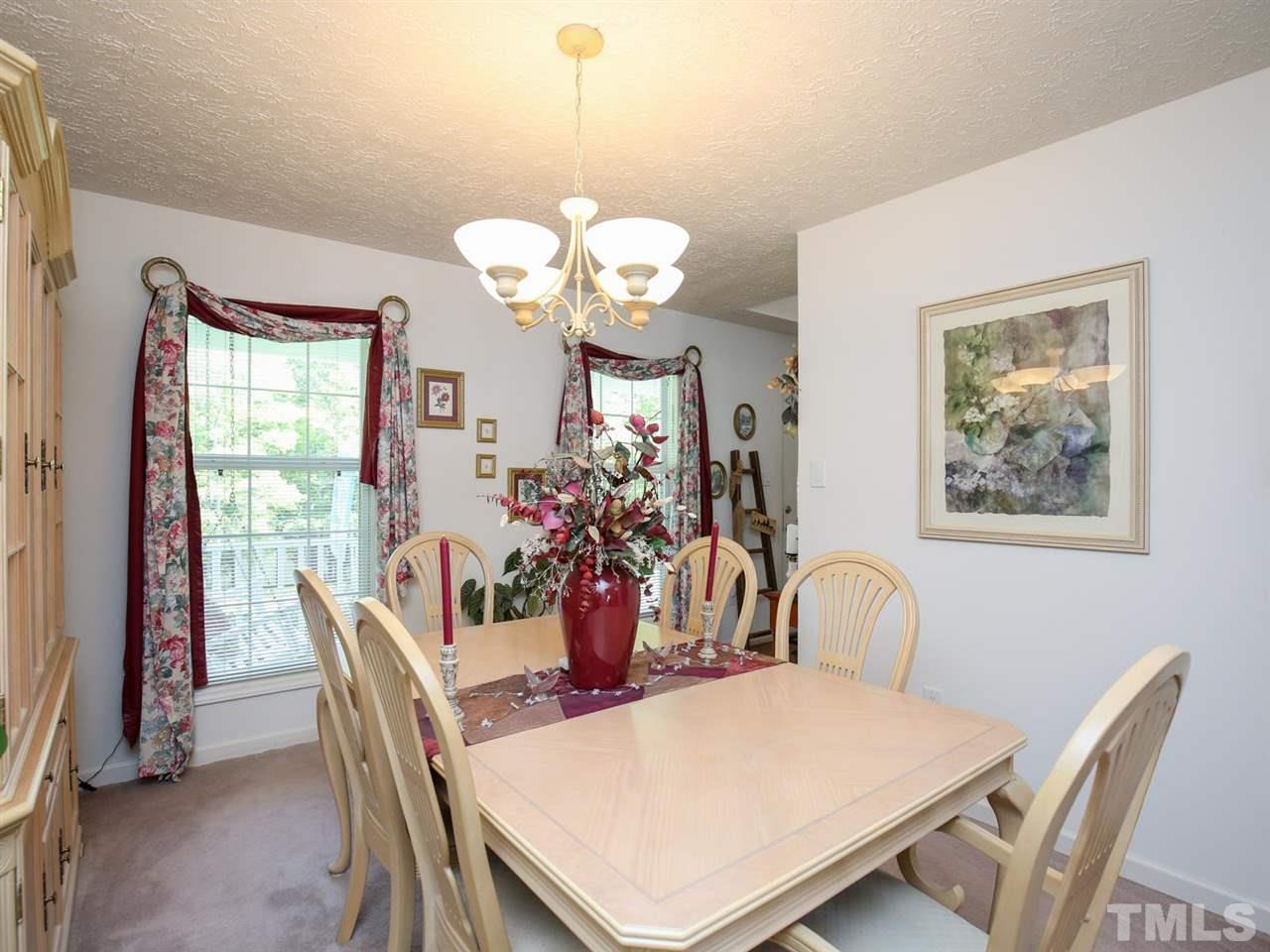 4040 Pine Ridge Road Franklinton, NC 27525 - Photo 10 of 30 a view of a dining room with furniture and chandelier