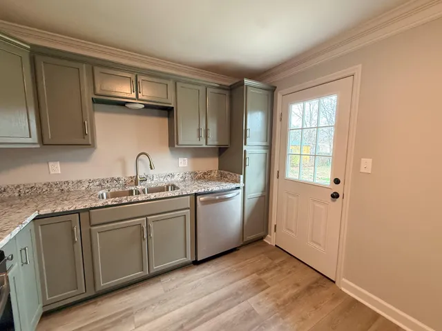 a kitchen with a sink cabinets and window