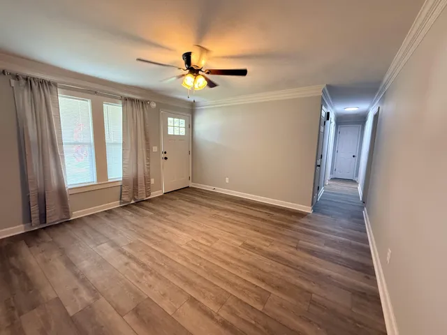 wooden floor in an empty room with a window