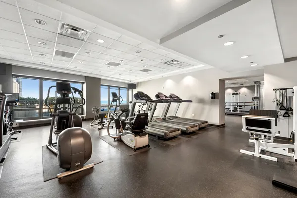 a room with gym equipment and a large mirror