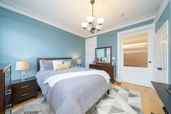 a bedroom with a bed and a lamp