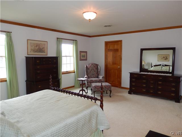 2764 Lapp Road Allentown, PA 18104 - Photo 18 of 27 a bedroom with a bed and wooden floor
