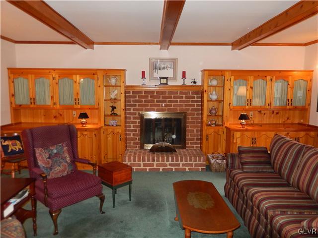 2764 Lapp Road Allentown, PA 18104 - Photo 5 of 27 a living room with furniture a fireplace and a floor to ceiling window