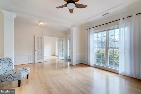 a kitchen with kitchen island granite countertop a sink large window appliances and cabinets