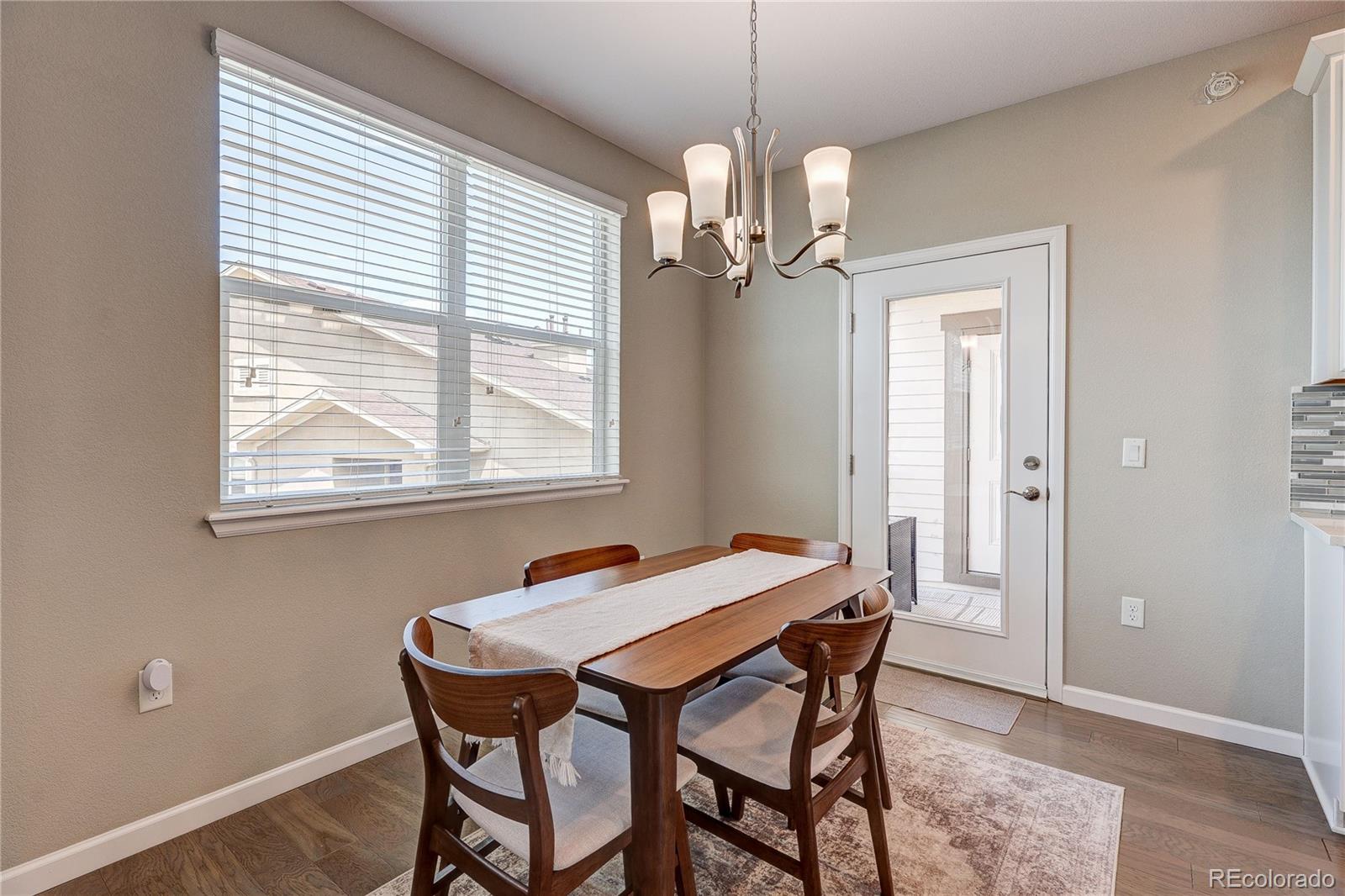 4777 Copeland Circle, Unit 204 Highlands Ranch, CO 80126 - Photo 13 of 39 a dining room with a table and chairs