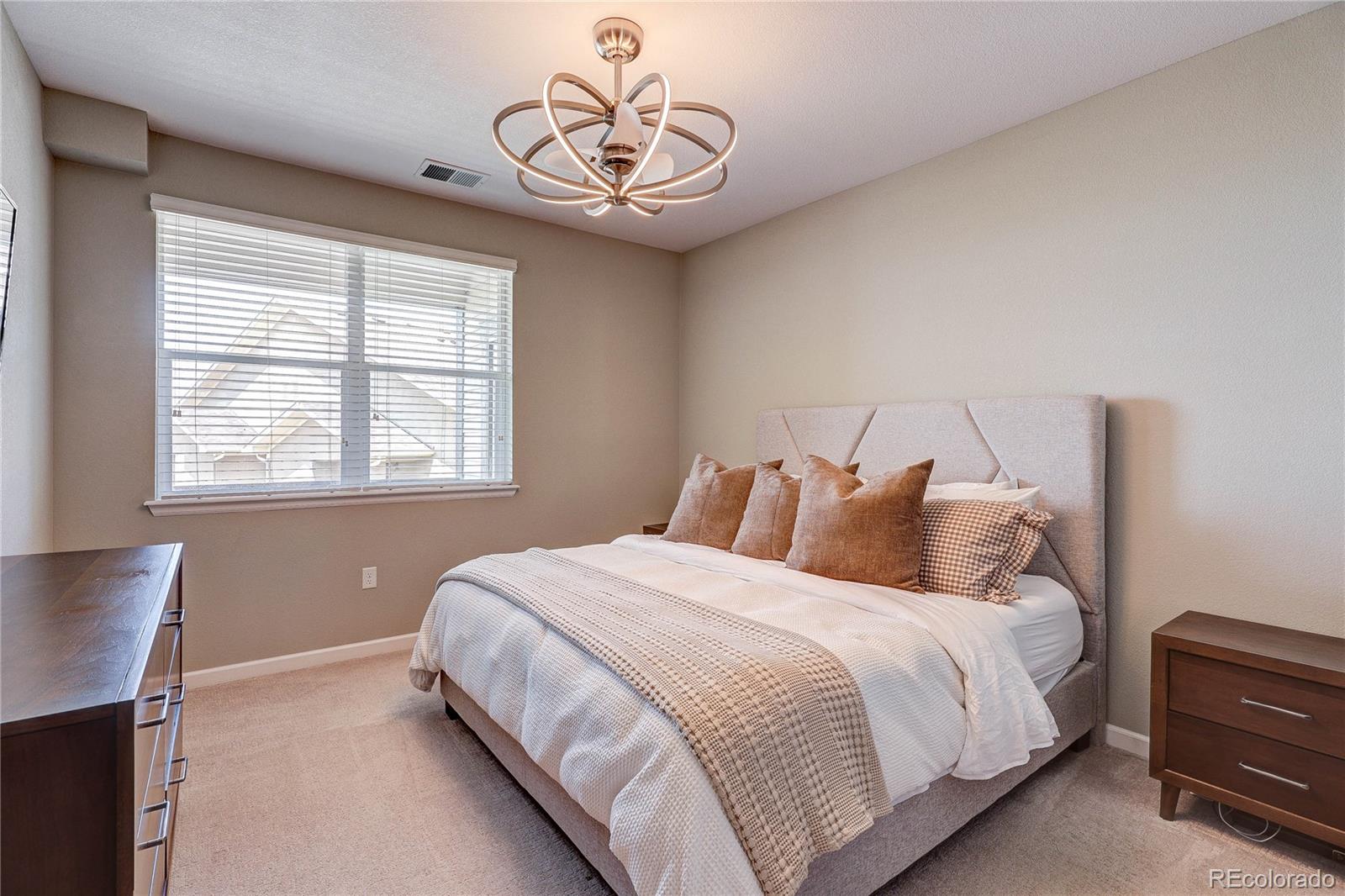 4777 Copeland Circle, Unit 204 Highlands Ranch, CO 80126 - Photo 15 of 39 a bedroom with bed and a window