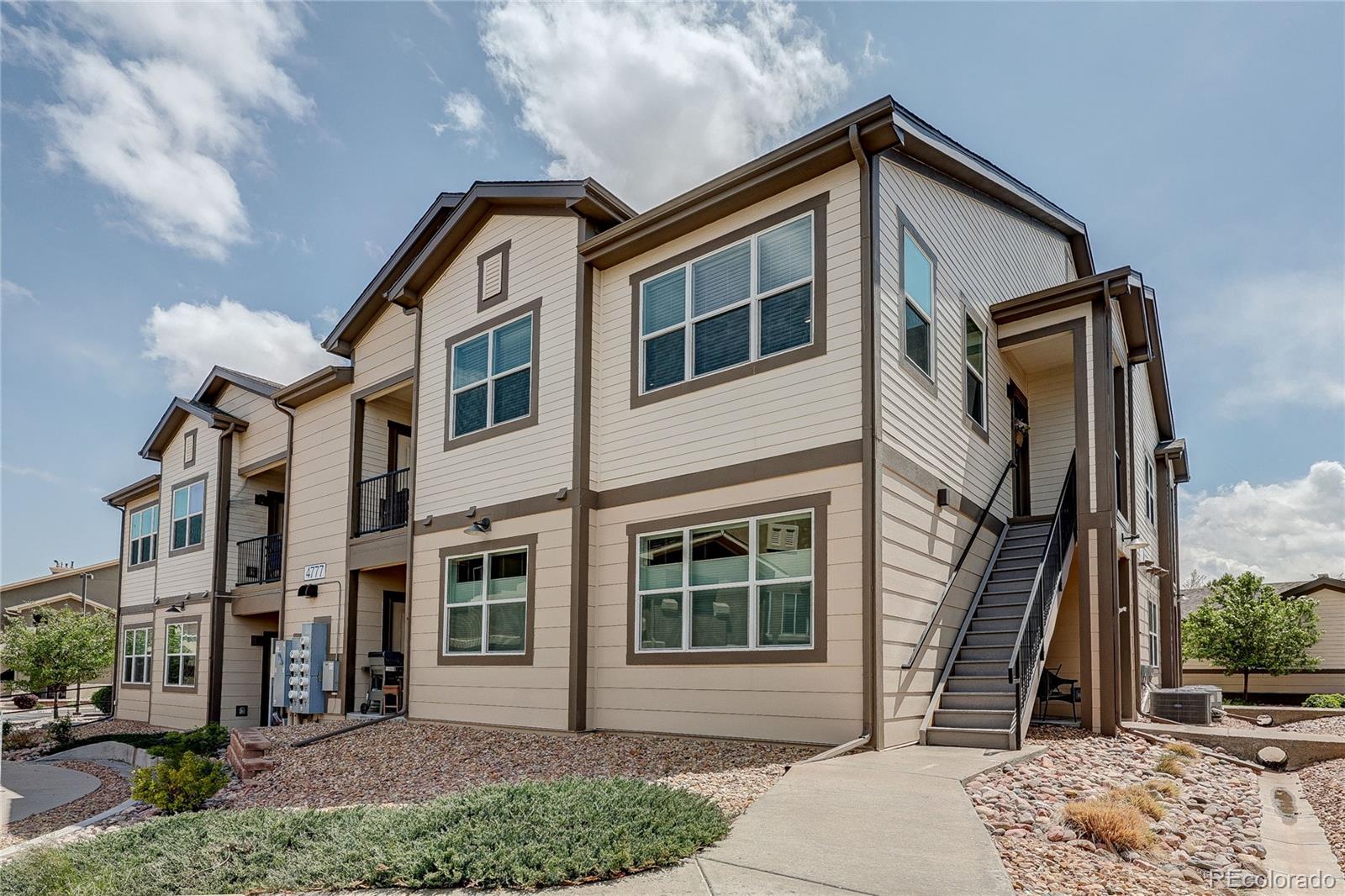 4777 Copeland Circle, Unit 204 Highlands Ranch, CO 80126 - Photo 2 of 39 a front view of a house with a yard