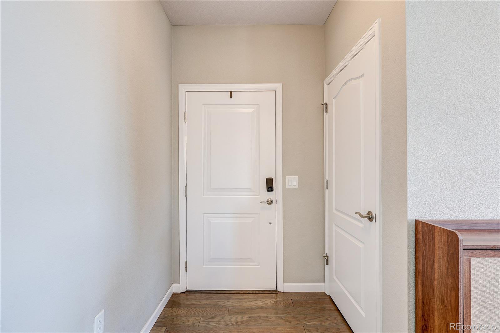 4777 Copeland Circle, Unit 204 Highlands Ranch, CO 80126 - Photo 4 of 39 a view of a hallway with wooden floor