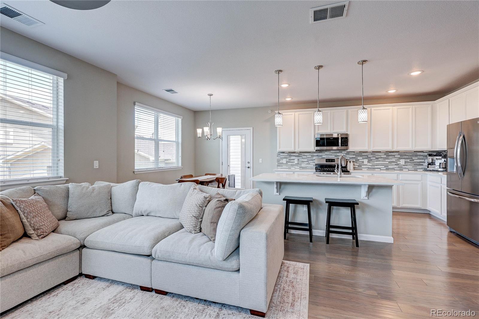 4777 Copeland Circle, Unit 204 Highlands Ranch, CO 80126 - Photo 5 of 39 a living room kitchen with furniture and kitchen view
