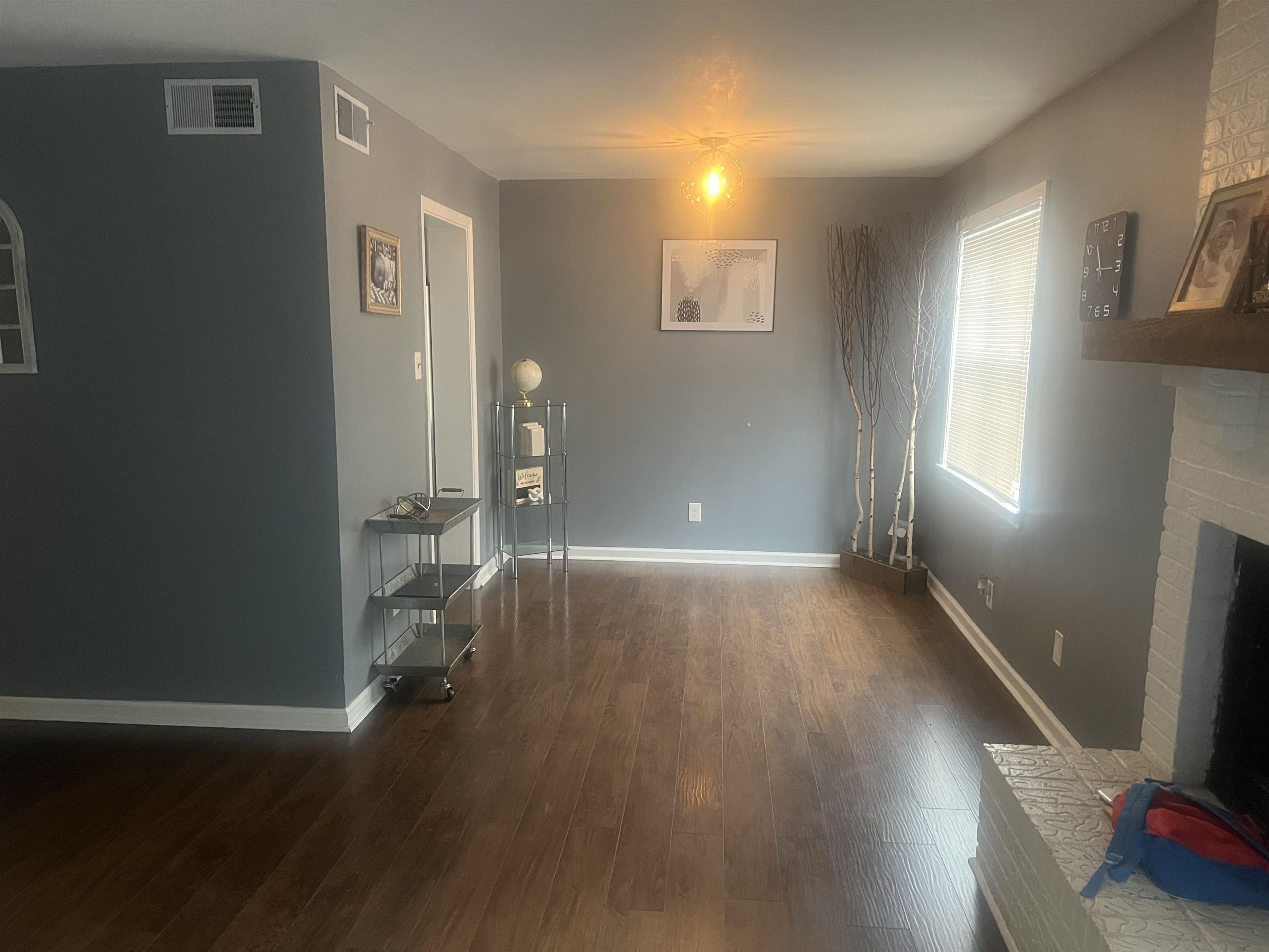 3096 Castlebay Road, Unit 3096 Memphis, TN 38128 - Photo 5 of 10 an empty room with wooden floor and windows