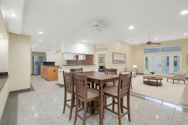 a large kitchen with a table and chairs
