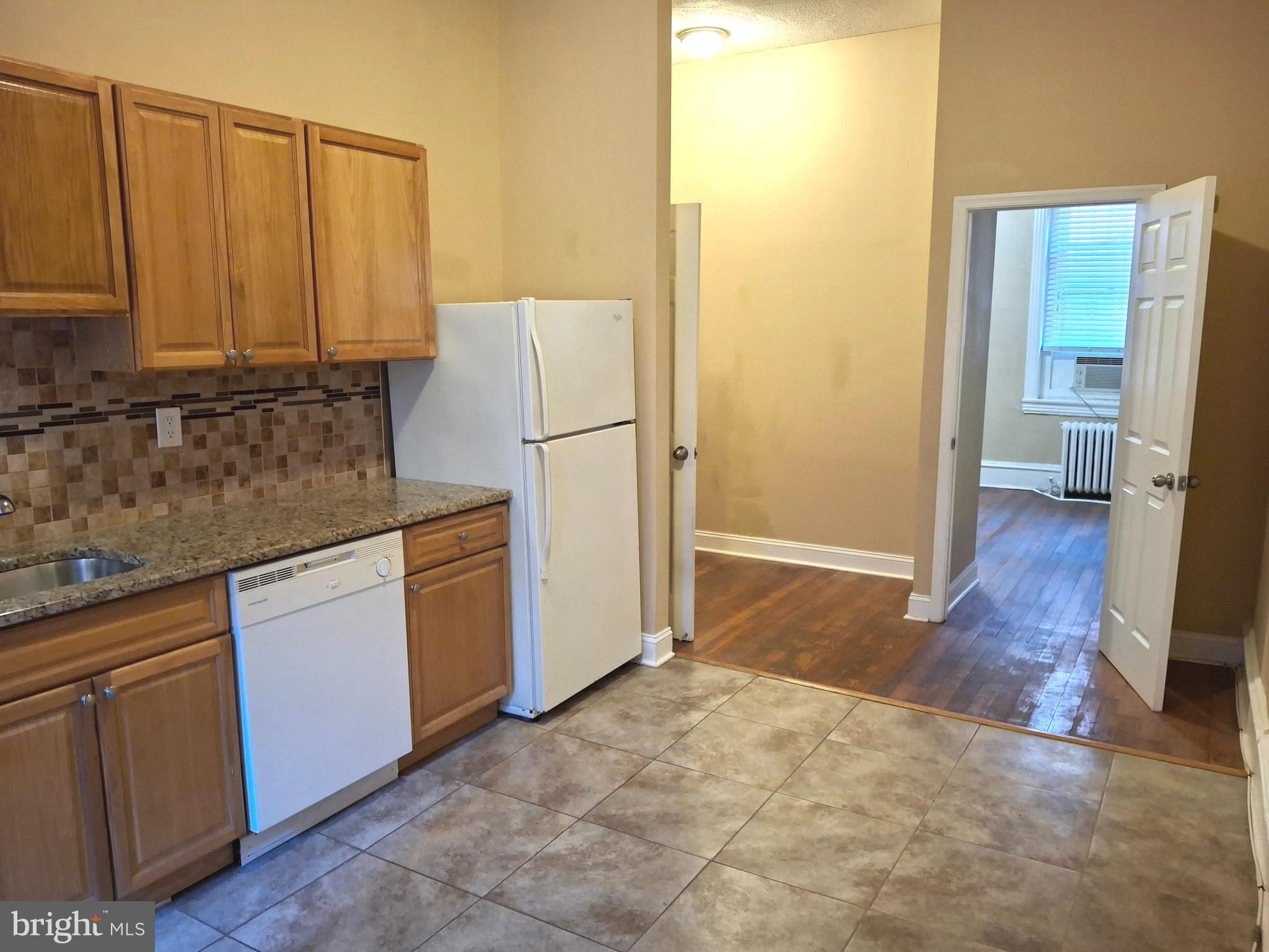 310 South 12th Street, Unit 1F Philadelphia, PA 19107 - Photo 4 of 12 a kitchen with a refrigerator sink and cabinets