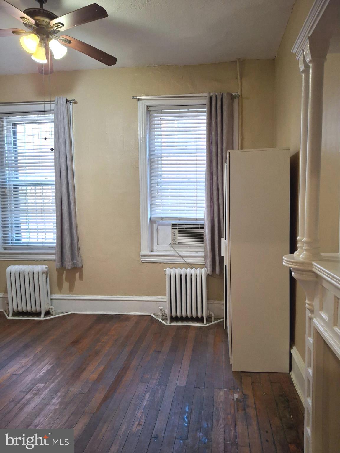 310 South 12th Street, Unit 1F Philadelphia, PA 19107 - Photo 7 of 12 an empty room with wooden floor and windows