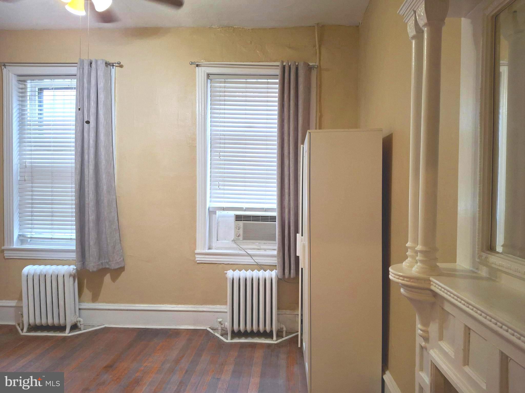 310 South 12th Street, Unit 1F Philadelphia, PA 19107 - Photo 8 of 12 a view of wooden floor and windows in a room