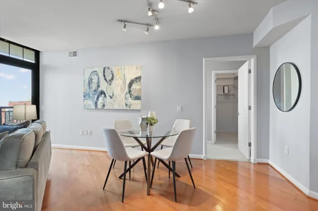 a dining room with furniture and a mirror