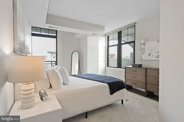 a bedroom with a bed and a large window