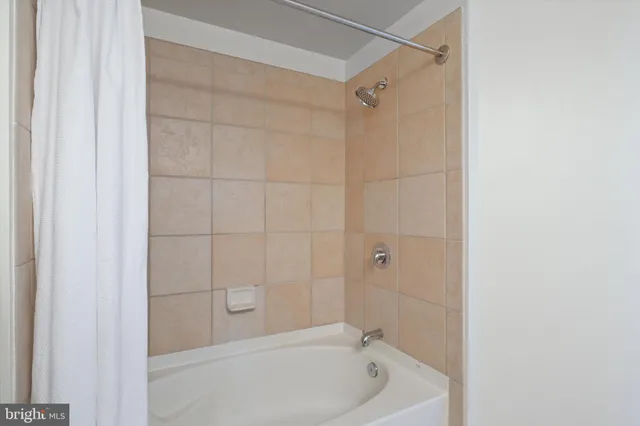 a bathroom with a shower and a bath tub