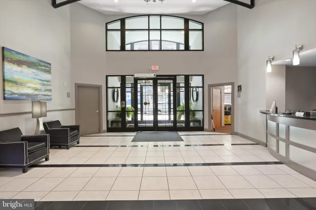 a living room with a large window and a rug
