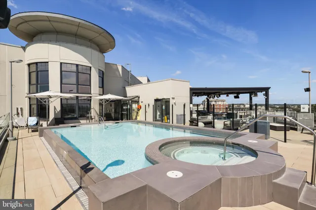 swimming pool view with a seating space