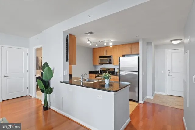 a kitchen with a refrigerator and a sink