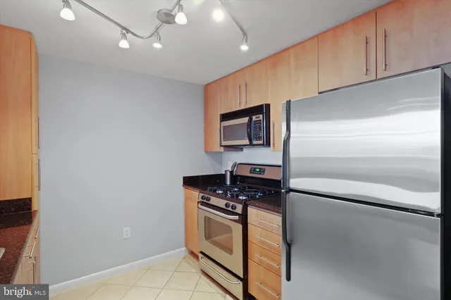 a kitchen with granite countertop cabinets and steel stainless steel appliances