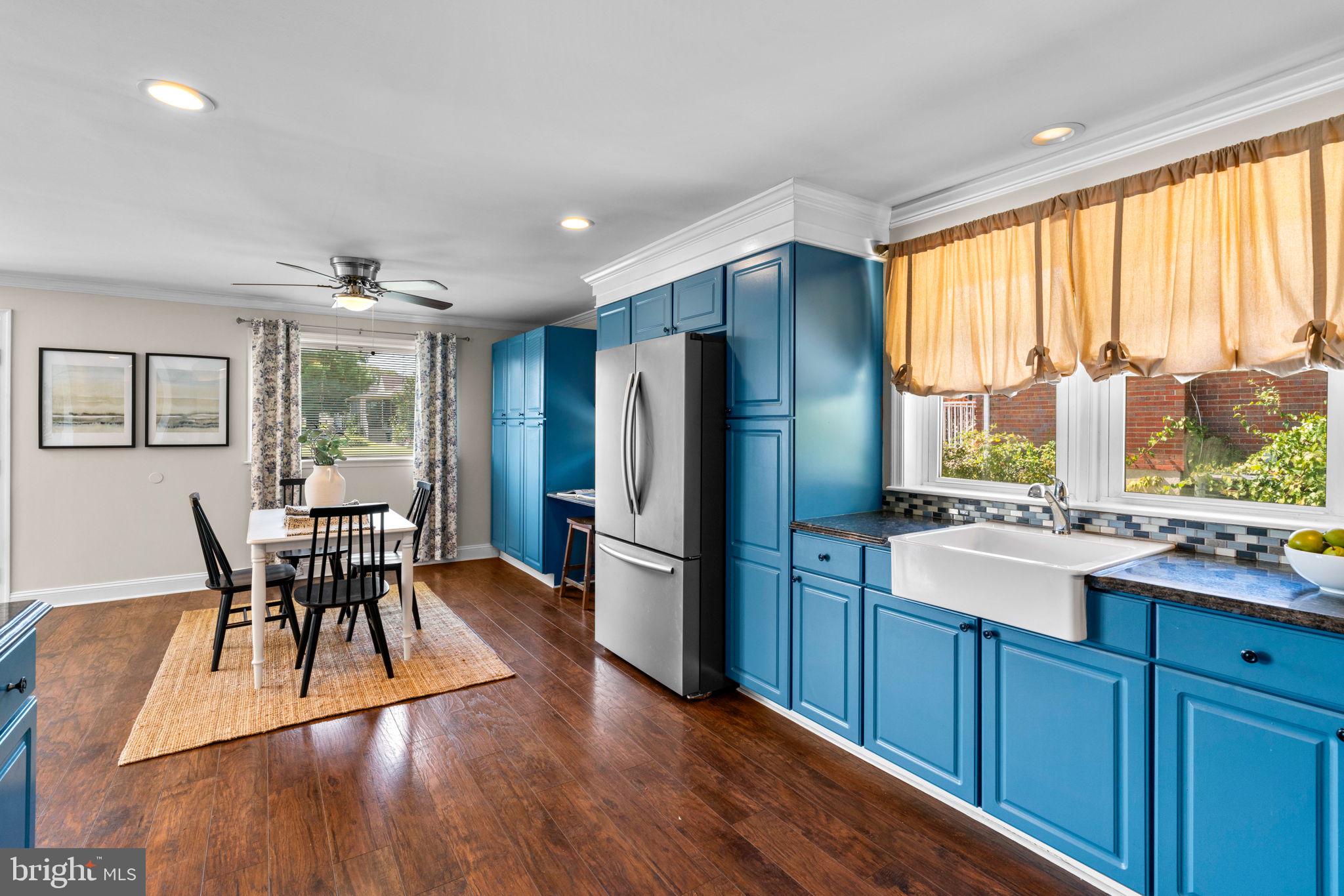 1221 Berkwood Road Baltimore, MD 21237 - Photo 11 of 34 a kitchen with a table chairs refrigerator and cabinets