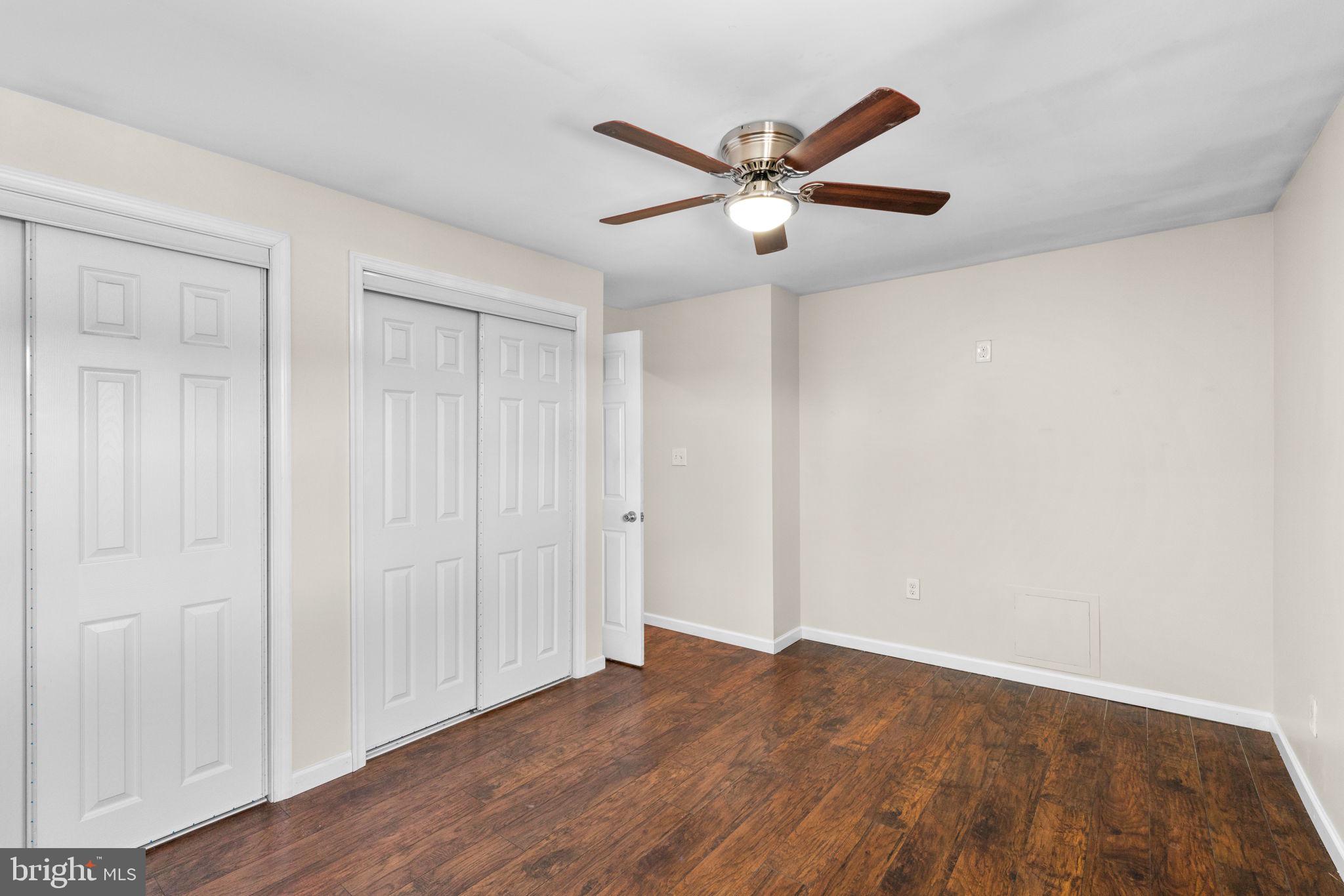 1221 Berkwood Road Baltimore, MD 21237 - Photo 13 of 34 a view of a big room with wooden floor closet and fan