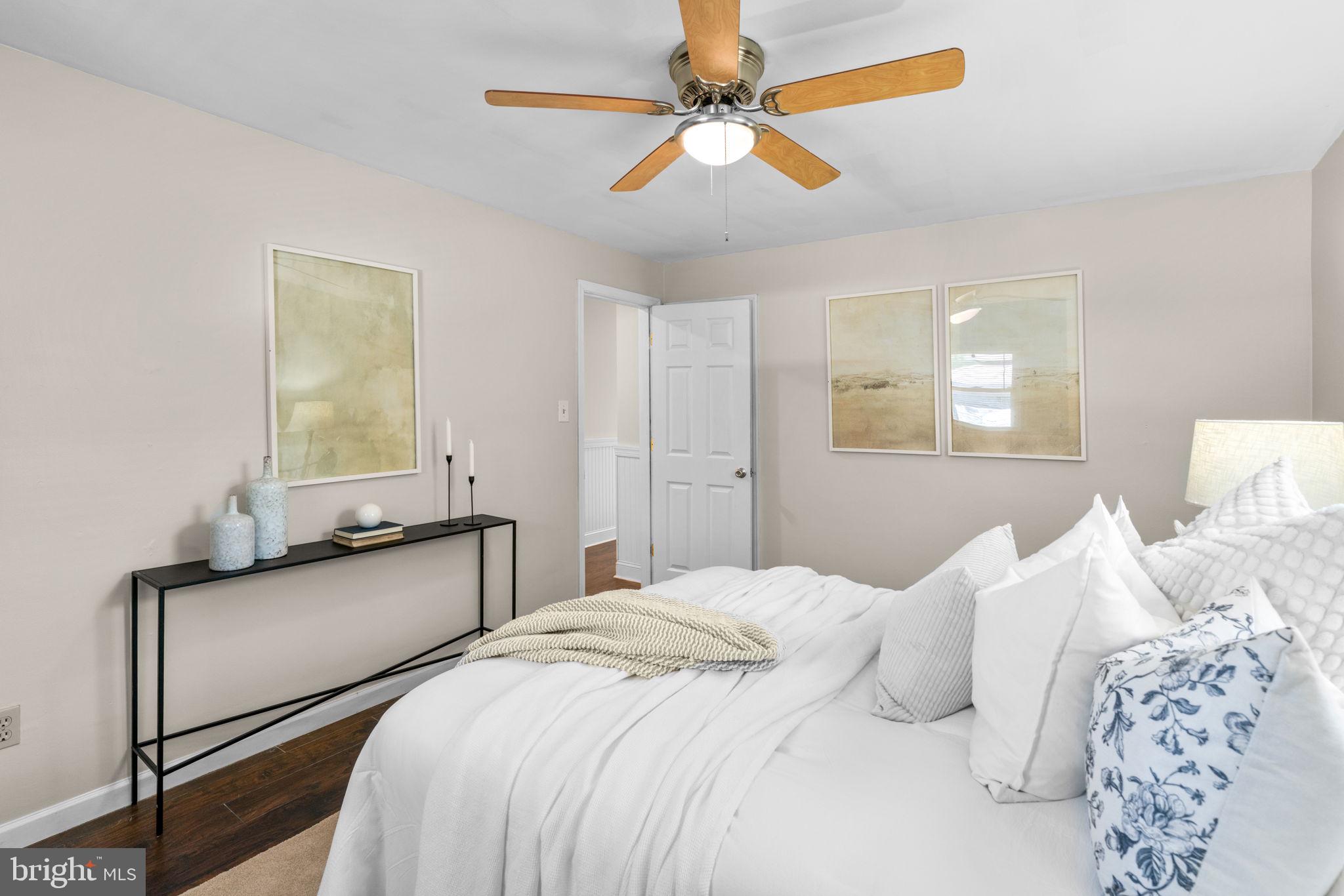 1221 Berkwood Road Baltimore, MD 21237 - Photo 15 of 34 a bedroom with a bed and a chandelier