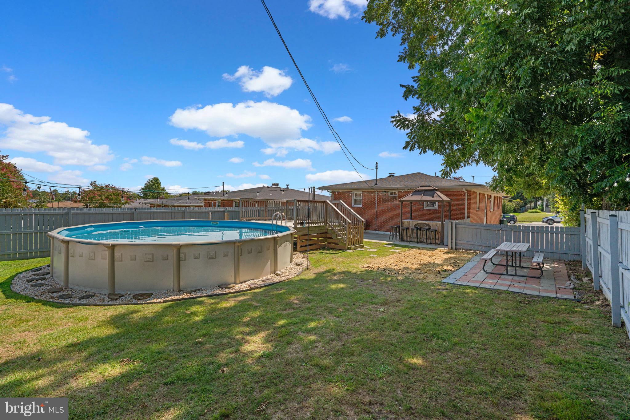 1221 Berkwood Road Baltimore, MD 21237 - Photo 33 of 34 a view of a house with a big yard and large tree