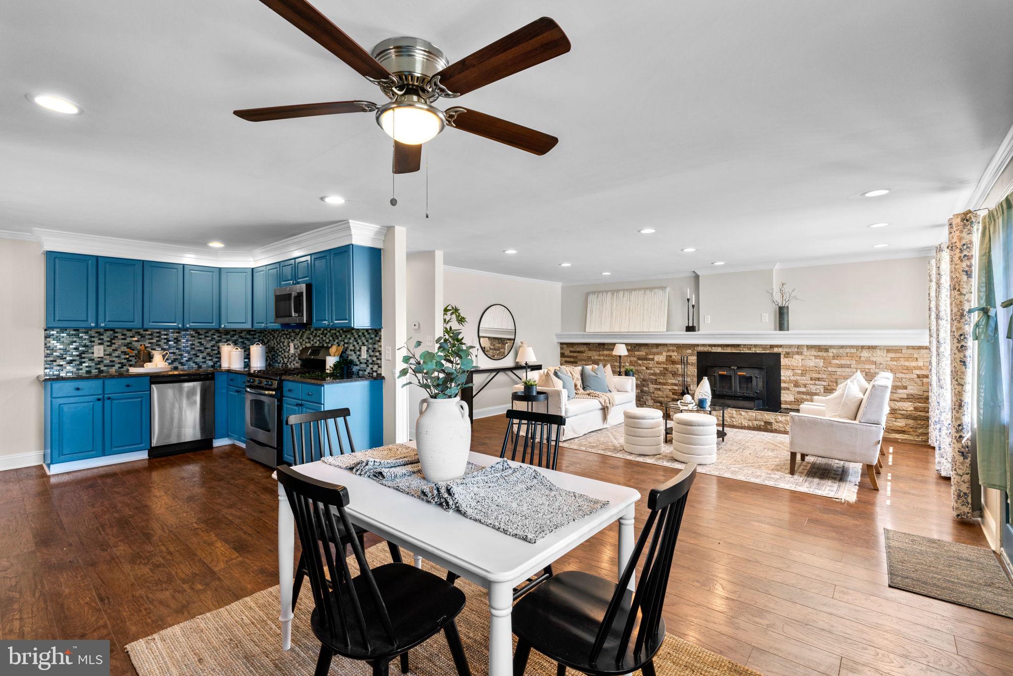 1221 Berkwood Road Baltimore, MD 21237 - Photo 8 of 34 a view of a dining room and livingroom with furniture wooden floor and a kitchen view