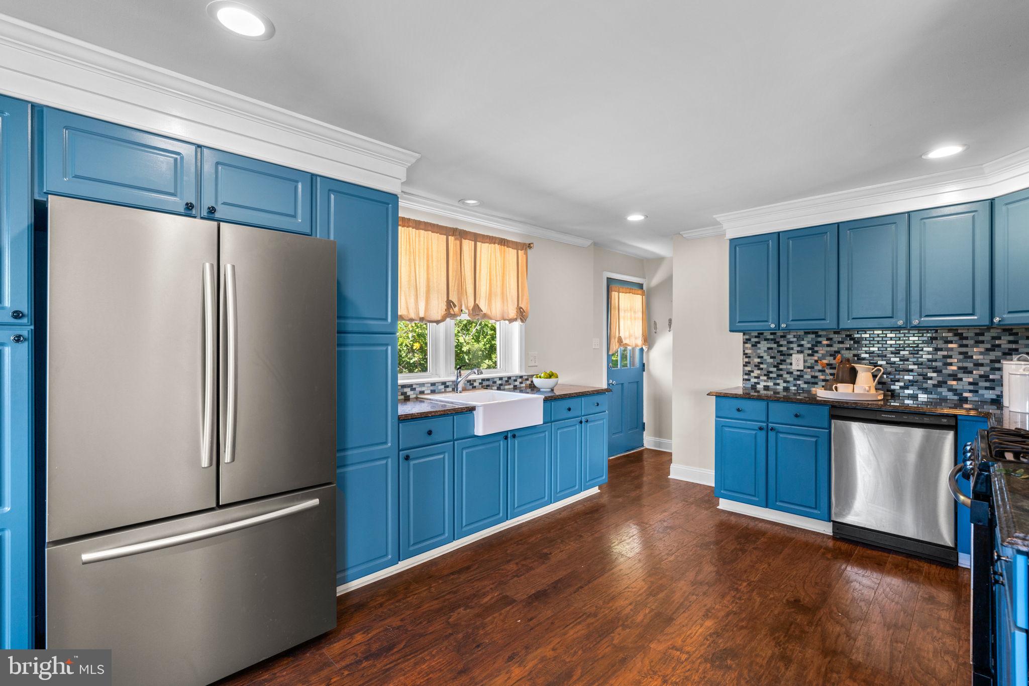 1221 Berkwood Road Baltimore, MD 21237 - Photo 9 of 34 a kitchen with granite countertop stainless steel appliances and wooden cabinets