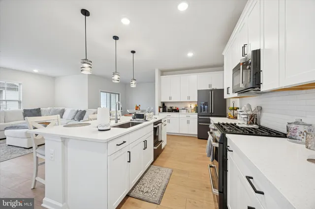 a kitchen with a sink a stove and cabinets