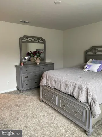 a bedroom with a bed and a mirror