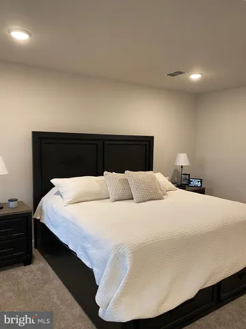 a bedroom with a bed and a night stand