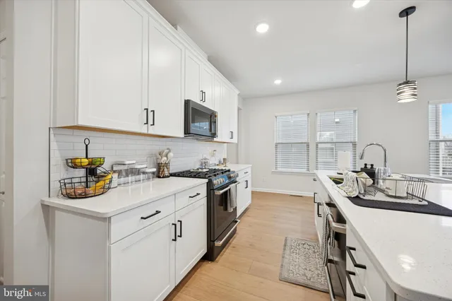 a kitchen with a sink stove and cabinets