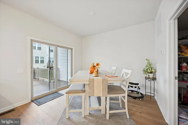 a view of a dining room with furniture wooden floor and a potted plant