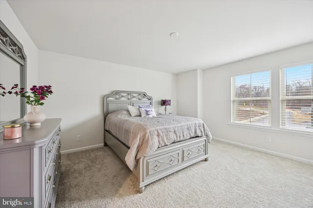 a bedroom with a bed and a table