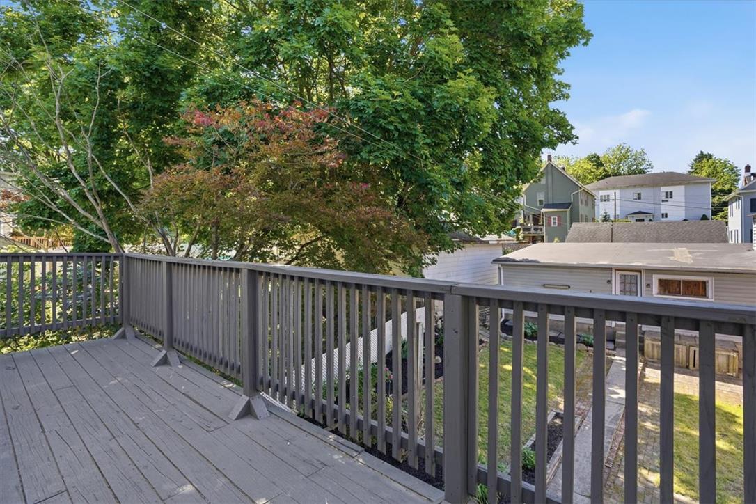 110 Messinger Street Bangor, PA 18013 - Photo 28 of 39 An elevated wood deck provides a serene outdoor space, perfect for relaxing amidst the lush greenery.