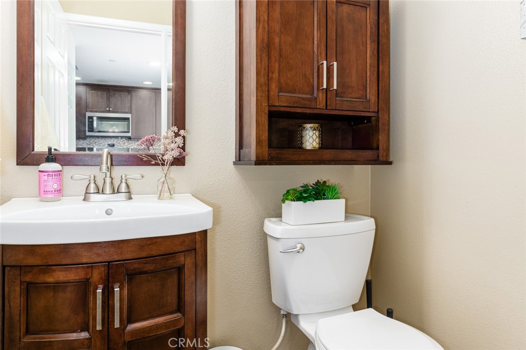 1113 Calabria Street Santee, CA 92071 - Photo 13 of 35 a bathroom with a sink a toilet and mirror