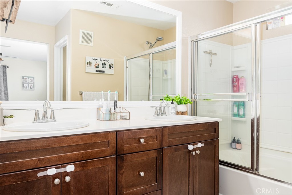 1113 Calabria Street Santee, CA 92071 - Photo 18 of 35 a bathroom with a granite countertop sink a mirror and a shower