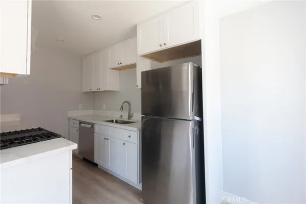 a kitchen with a refrigerator and a stove