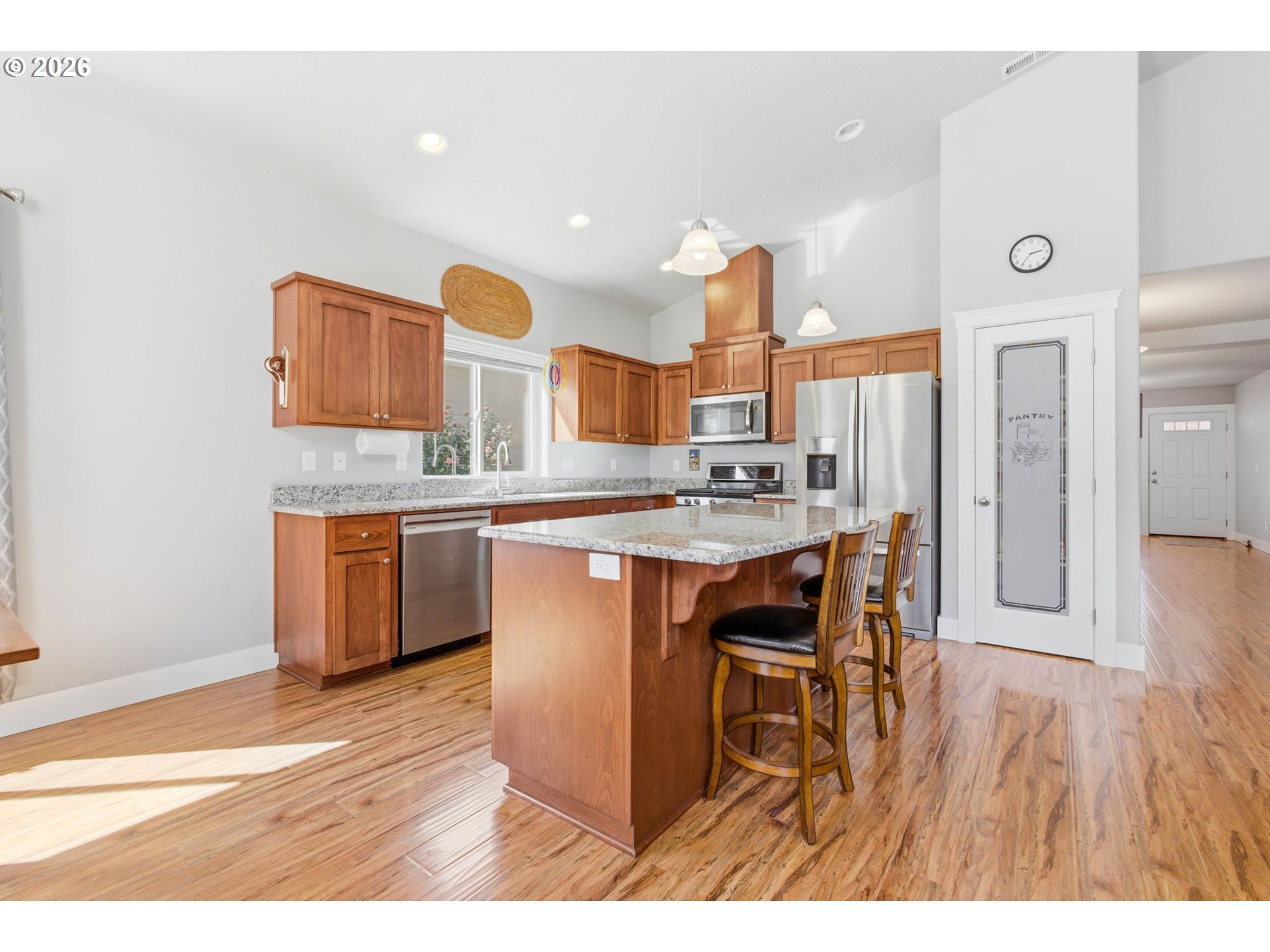 2418 Equestrian Loop South Salem, OR 97302 - Photo 13 of 39 a open kitchen with stainless steel appliances kitchen island granite countertop a sink and cabinets
